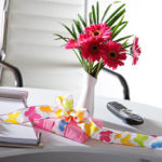 Present and flower vase on office table